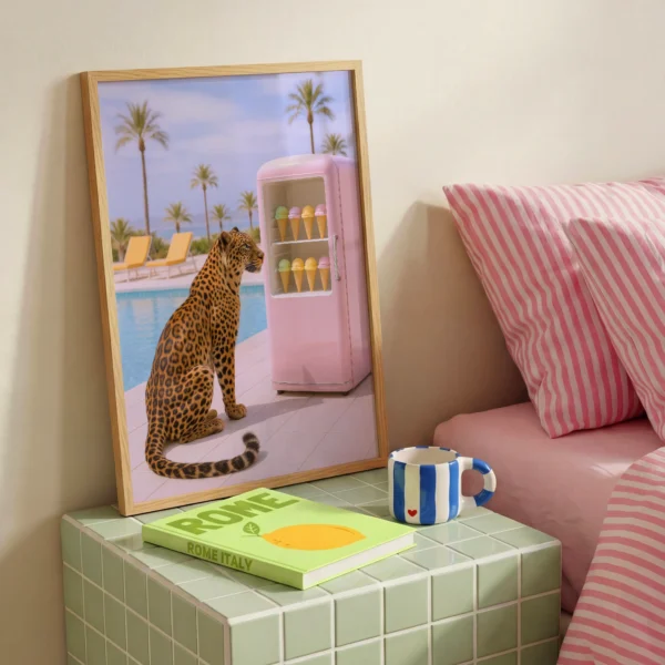 Leopard ice cream poolside wall art image 2 with a leopard in a poolside setup with ice cream cues, a pink fridge accent, and sunny resort color