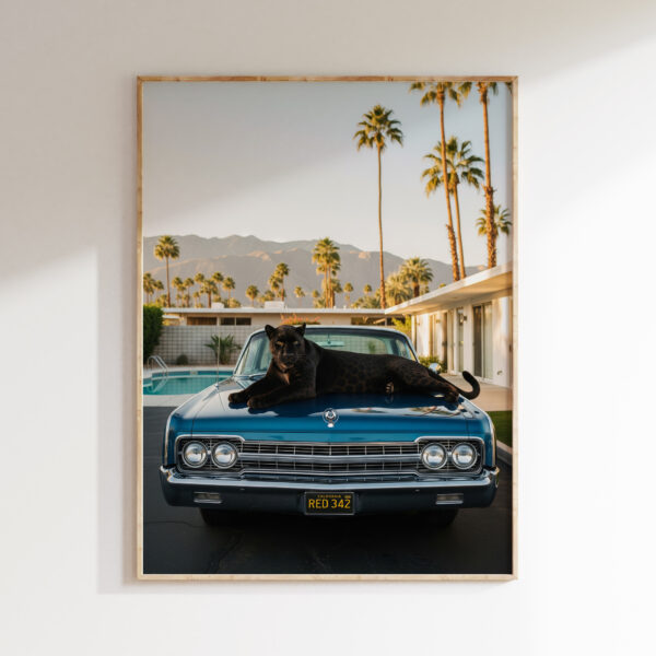 Framed black panther wall art at poolside motel in Palm Springs-inspired style.