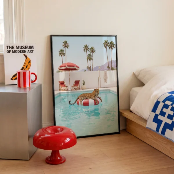 Framed leopard pool float wall art styled in a Palm Springs-inspired bedroom interior