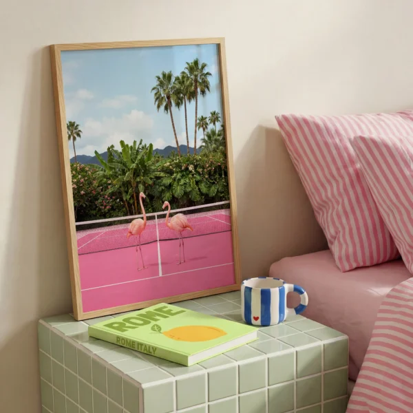 Flamingo tennis court print styled beside a pink bed and green tiled side table