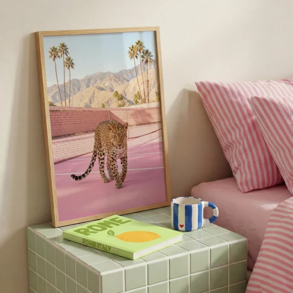Leopard on pink tennis court framed print beside pink striped bedding