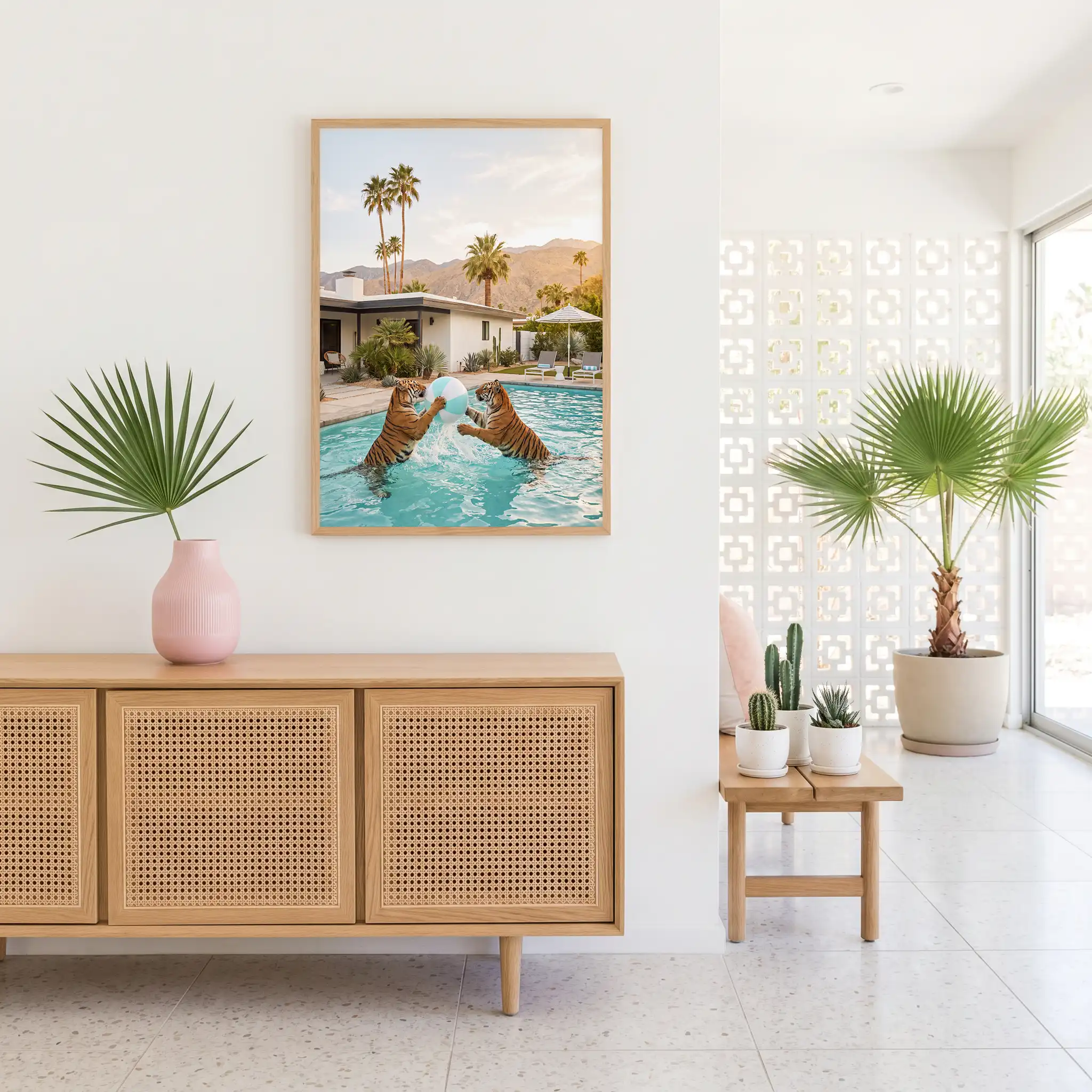 Two tigers beach ball wall art above a cane-front console