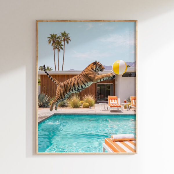 Framed tiger jumping pool wall art showing a tiger leaping toward a yellow beach ball above turquoise water
